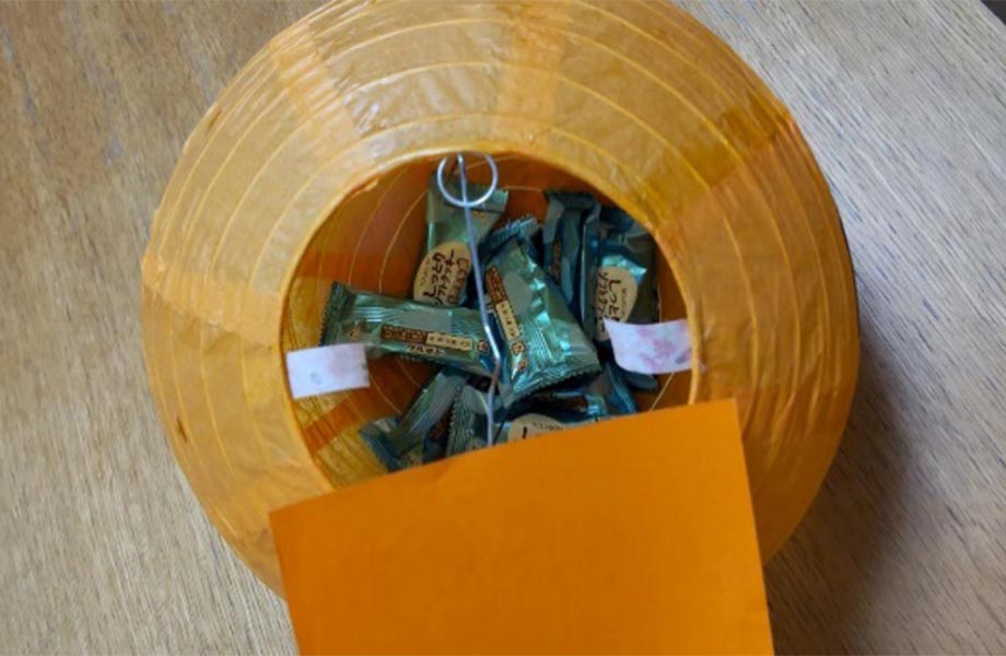 提灯の底の大きさに合わせて折り紙を切る。提灯の内側から底にテープを貼り、折り紙を載せて貼り付ければ完成！