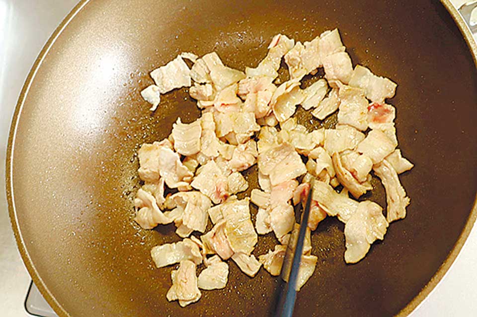 （4）のフライパンで（3）の豚バラ肉を焼く。軽く焦げ目が付いたら、キャベツを加えて炒め合わせる。